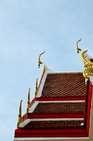 Old thai temple roof top  with blue sky の写真素材