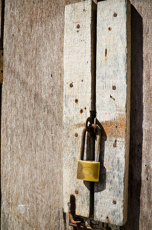 Old rusty hardwood door with key lockの写真素材