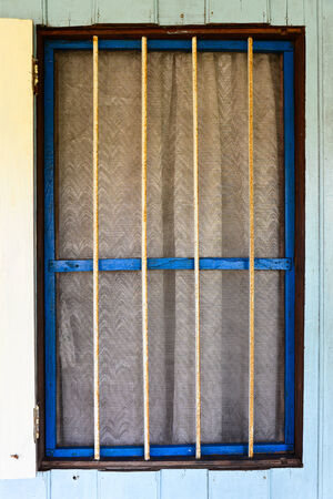 Old rusty blue frame windowの写真素材