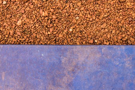 Old dirty blue wall closeup with brown pebble in backの写真素材