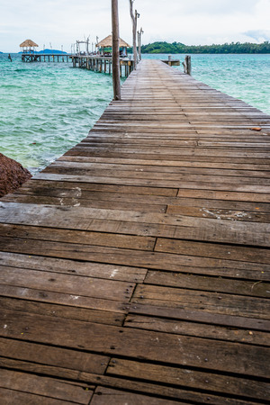 Image of long hardwood bridge over the sea in Thailandの写真素材