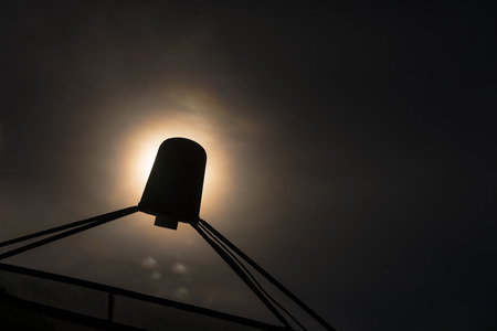 Silhouette image of satellite dish with moon light in backgroundの写真素材