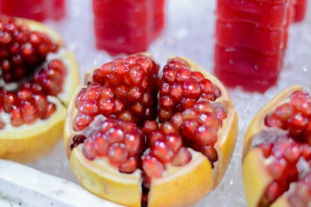Pomegranate juice and pomegranate juice on a pile of ice.の写真素材