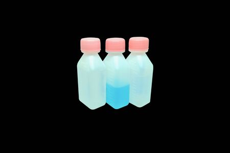 Bottle with liquid medicine. Transparent  vial with lid on backgroundの写真素材