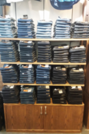 blurred photo, Blurry image, Jeans Denim pants on the shelvesの写真素材