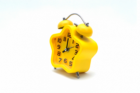 The yellow alarm clock isolated on white background