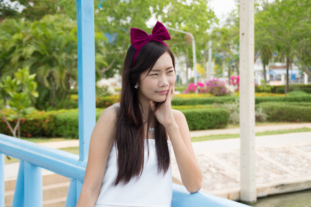 Attractive young woman enjoying her time outside in public parkの写真素材