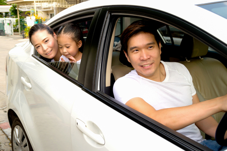 Parents and daughters are happy with their cars.の写真素材