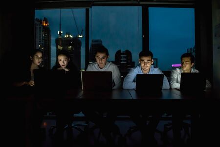 Group of business people working overtime in nighttime.の写真素材