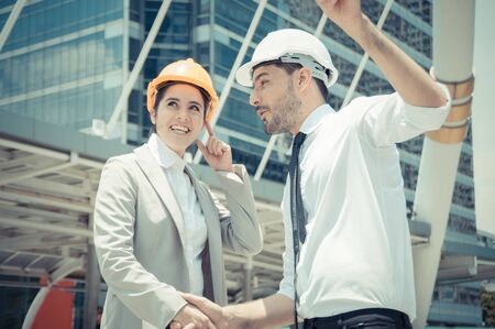 Professional engineers, young men and young women are planning construction.の写真素材
