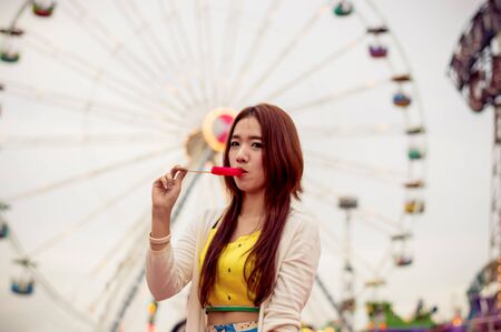 Beautiful women are happy in the amusement park.の写真素材