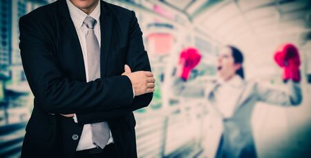 businesswoman wearing red boxing gloves throwing a punchの写真素材