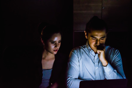 businesspeople working overtime in nighttime at the office.の写真素材