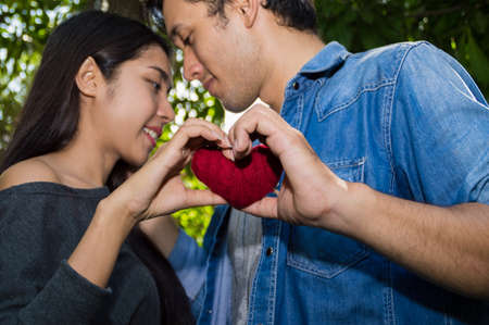 Young people are showing love in the garden.の写真素材