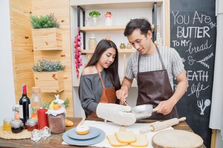 Lovers are cooking in the kitchen intently.の写真素材