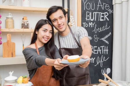 Lovers are cooking in the kitchen intently.の写真素材