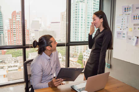 Youngs is working in office building backgroundの写真素材