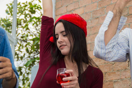 Young people holding glass talk in the party.の写真素材