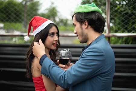 Young people holding glass talk in the party.の写真素材