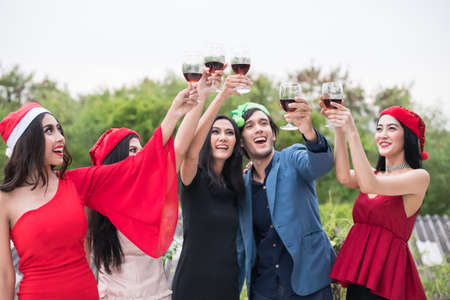 Young people holding glass talk in the party.の写真素材