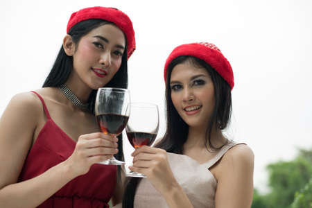 Young people holding glass talk in the party.の写真素材