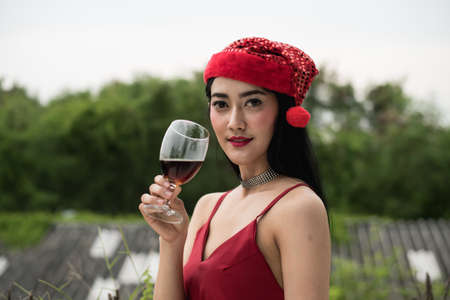 Young people holding glass talk in the party.の写真素材