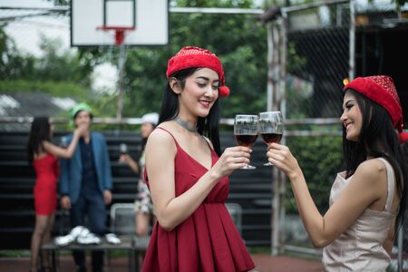 Young people holding glass talk in the party.の写真素材