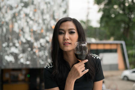 Young people holding glass talk in the party.の写真素材