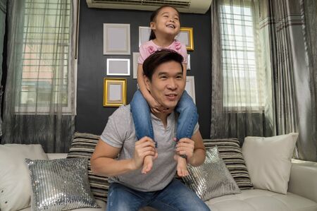 Young girls and parents are showing love in the home.の写真素材