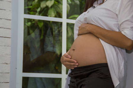 Abdominal women are doing activities within the home.