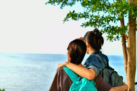 Beautiful girl is walking on the beach happily.の写真素材