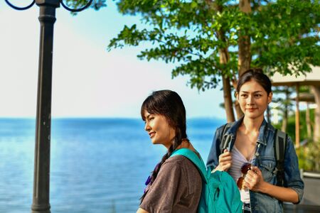 Beautiful girl is walking on the beach happily.の写真素材