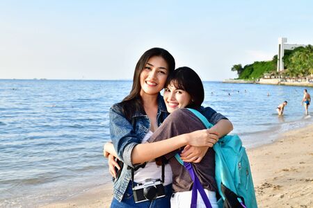 Beautiful girl is walking on the beach happily.の写真素材