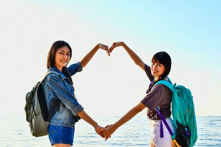Beautiful girl is walking on the beach happily.の写真素材