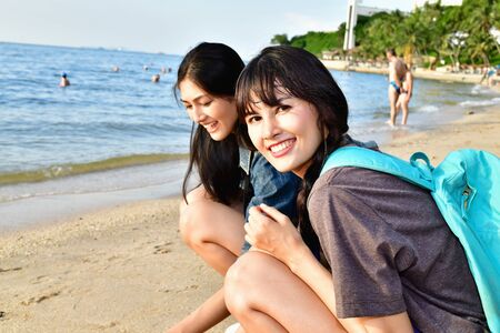 Beautiful girl is walking on the beach happily.の写真素材