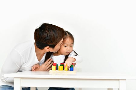 Parents are teaching children to do homework.の写真素材