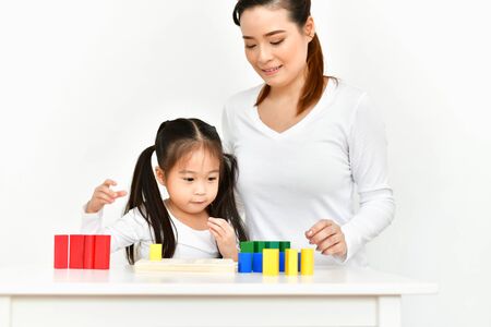 Parents are teaching children to do homework.