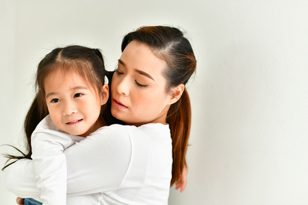 Mom is comforting her baby in the house.の写真素材
