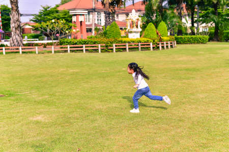 The girl is playing in the park.の写真素材