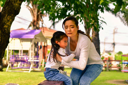 Mom is taking care of the injured daughter.の写真素材