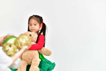 Little girl celebrates Christmas with red Santa dress.の写真素材