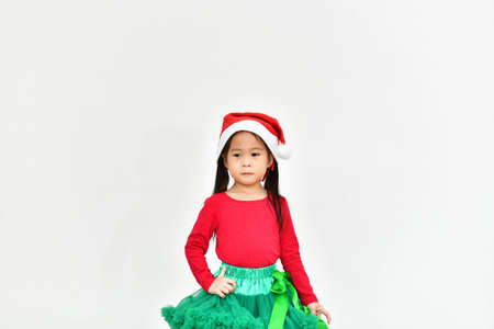 Little girl celebrates Christmas with red Santa dress.の写真素材