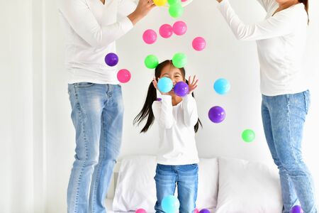 Parents and children are playing ball happily.の写真素材
