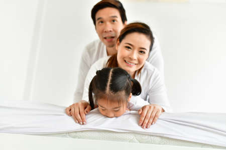 Parents and children are expressing emotions in the home.の写真素材