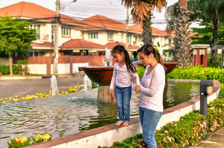 Mother and daughter come out to Loy Krathong at the pool on a traditional day.の写真素材