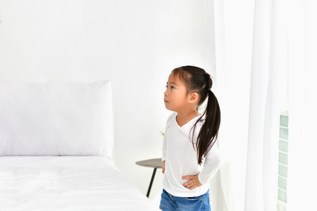 The girls are irritated in the white bedroom.の写真素材