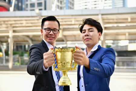 Young businessmen are competing for wins and trophies.の写真素材