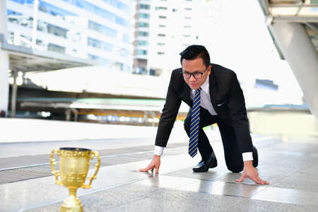 Young businessmen are competing for wins and trophies.の写真素材