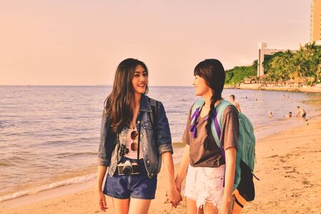 Beautiful girl is walking on the beach happily.の写真素材