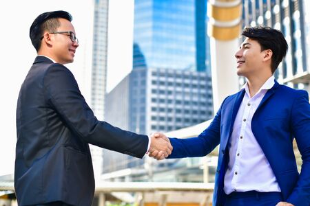Business Concept Contact, Young businessman Shake hands in the city.の写真素材
